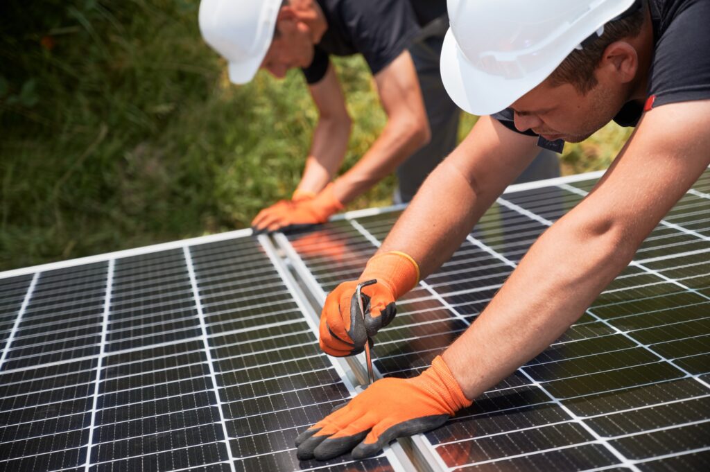 Solar panel installers working on a roof